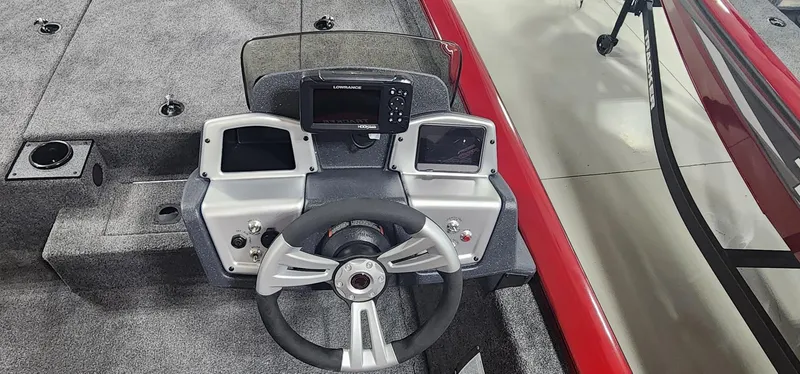 Slide: The Image of 2025 Tracker Pro Team 190 boat dashboard with steering wheel and navigation system. - 13