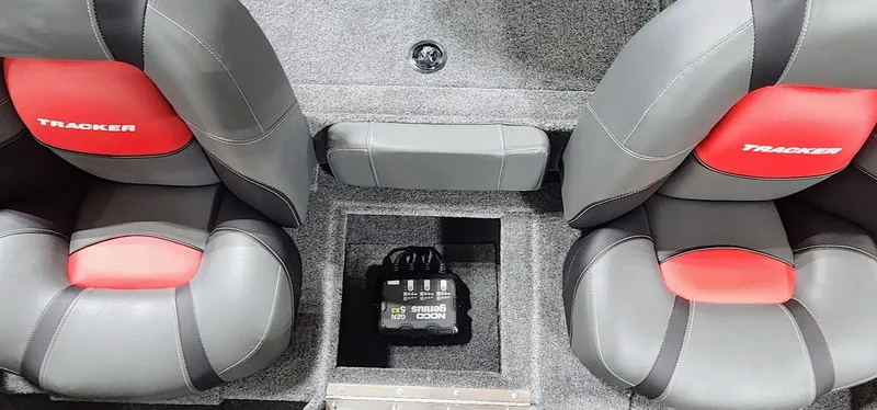 Slide: The Image of 2025 Tracker Pro Team 190 boat interior with gray and red seats, featuring a storage compartment. - 14