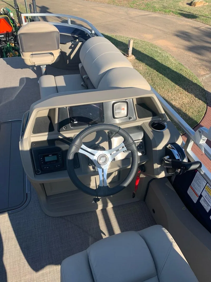 Slide: The Image of 2025 Sun Tracker Fishin' Barge 22 XP3 interior with beige seating and spacious layout. - 3