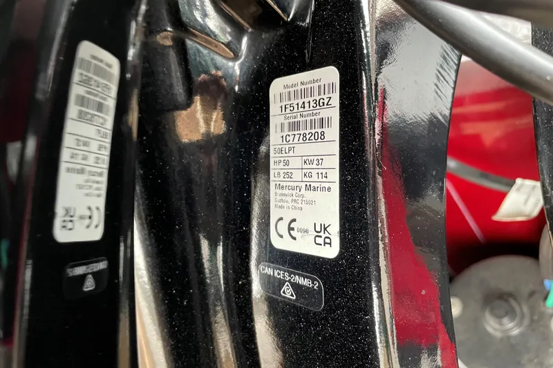 Slide: The Image of 2025 Tracker Bass Tracker Classic XL engine label with model and serial numbers. - 66