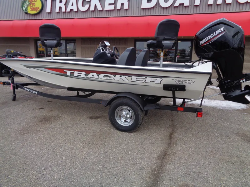 Slide: The Image of 2025 Tracker Pro Team 175 boat with Mercury engine displayed outside dealership. - 2