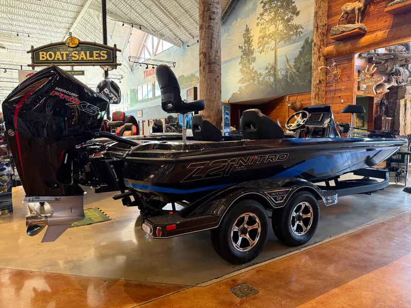 Slide: The Image of 2025 Nitro Z21 XL boat displayed in a showroom with rustic decor. - 1