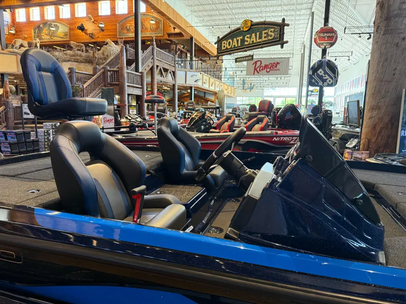 Slide: The Image of 2025 Nitro Z21 XL boat displayed in showroom with seating and steering wheel. - 3