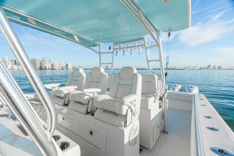 Slide: The Image of 2022 SeaHunter 46 CTS luxury boat interior with plush seating, ocean view, and city skyline. - 10