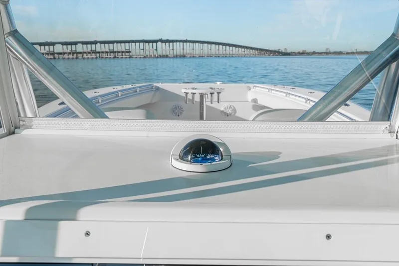 Slide: The Image of 2022 SeaHunter 46 CTS boat on water with bridge in background. - 12