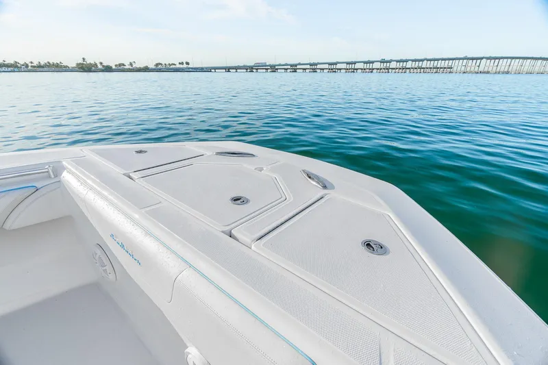 Slide: The Image of 2022 SeaHunter 46 CTS boat on calm water with bridge in background. - 14