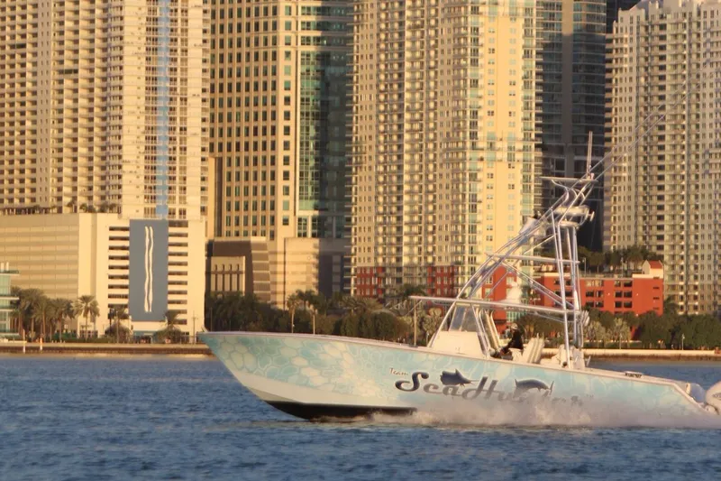 Slide: The Image of SeaHunter 46 CTS 2022 boat cruising near city skyline. - 24