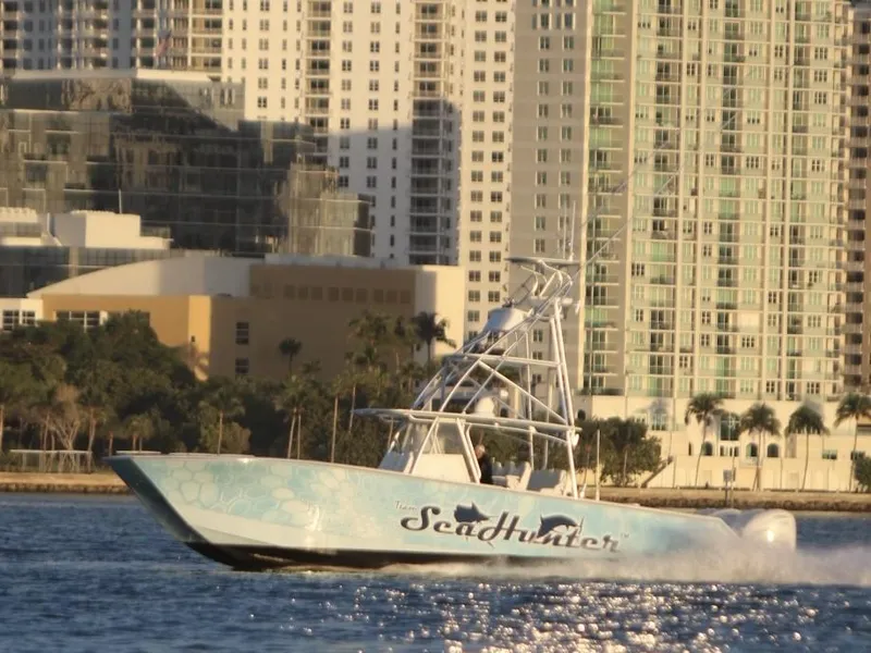 Slide: The Image of SeaHunter 46 CTS 2022 boat cruising near city skyline. - 27