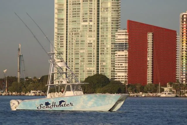 Slide: The Image of SeaHunter 46 CTS 2022 boat on water with city skyline background. - 28