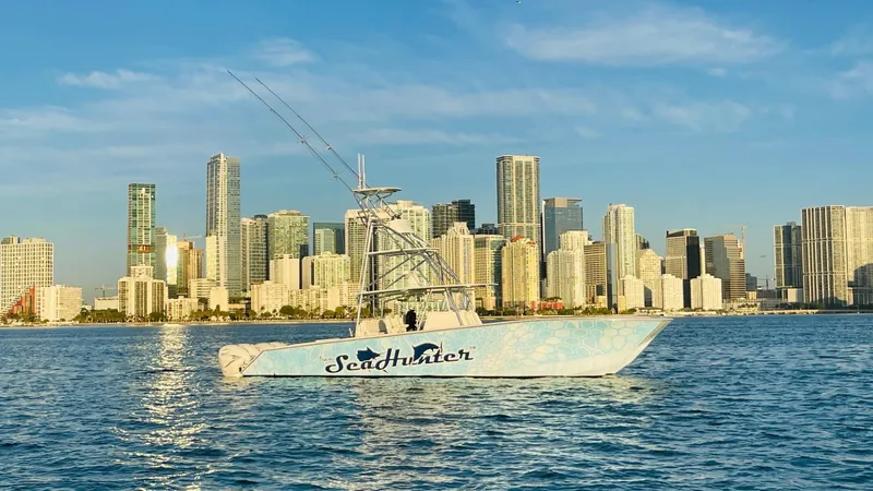 Slide: The Image of SeaHunter 46 CTS 2022 boat on water with city skyline background. - 6