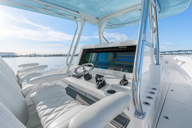 Slide: The Image of 2022 SeaHunter 46 CTS boat cockpit with modern navigation system and luxurious seating. - 9