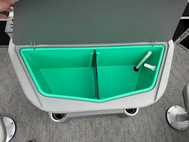 Slide: The Image of Trifecta 22 TRFCLE 2025 boat storage compartment with green interior and dividers. - 11