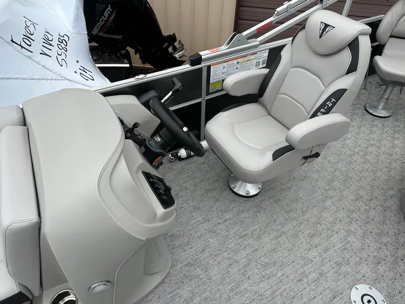 Slide: The Image of 2025 Trifecta 22 TRFCLE boat interior with plush captain's chair and steering console. - 5