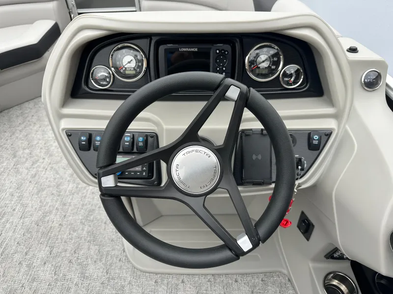 Slide: The Image of 2025 Trifecta 22 TRFCLE boat dashboard with steering wheel and gauges. - 6