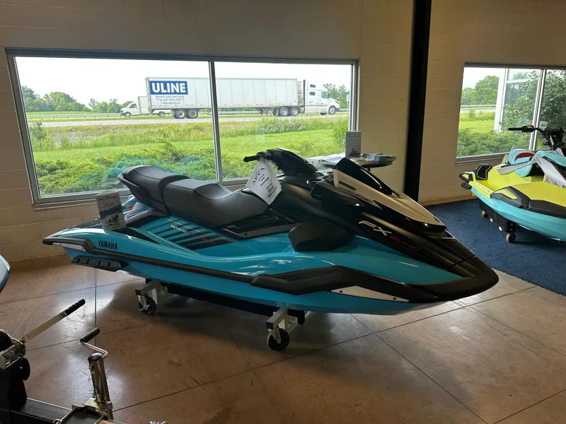 Slide: The Image of 2025 Yamaha WaveRunner FX SVHO in showroom, blue and black design, side view. - 4