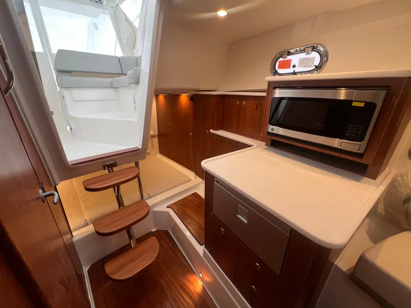 Slide: The Image of 2025 Pursuit OS 325 Offshore boat galley with grill and sink. - 11