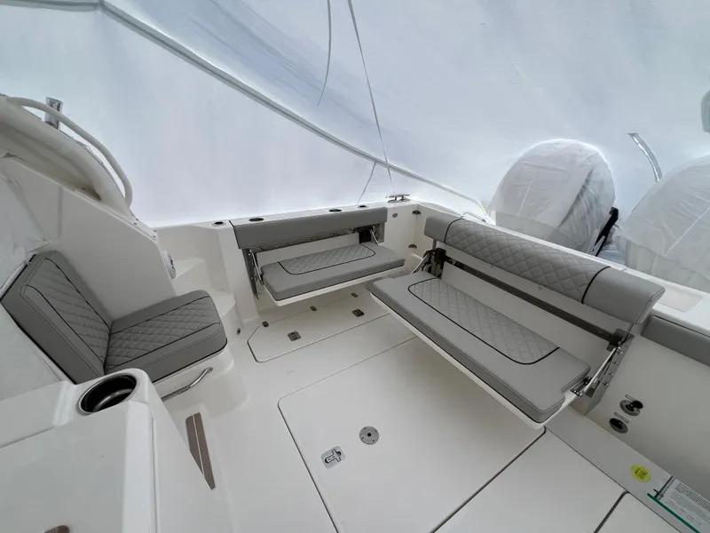 Slide: The Image of 2025 Pursuit OS 325 Offshore boat cockpit with modern controls and luxurious seating. - 16