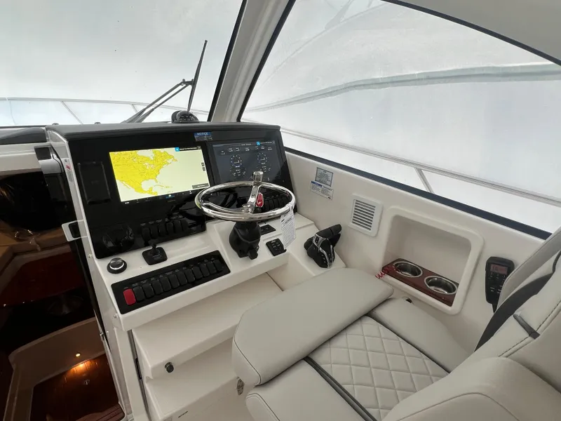 Slide: The Image of 2025 Pursuit OS 325 Offshore helm with modern navigation system and luxurious seating. - 41