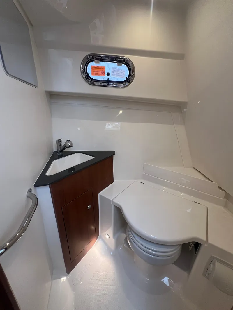 Slide: The Image of 2025 Pursuit OS 325 Offshore boat bathroom with sink and toilet. - 44