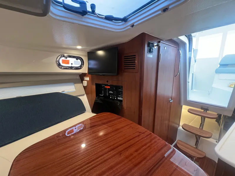 Slide: The Image of 2025 Pursuit OS 325 Offshore cabin interior with wood finish and modern amenities. - 47