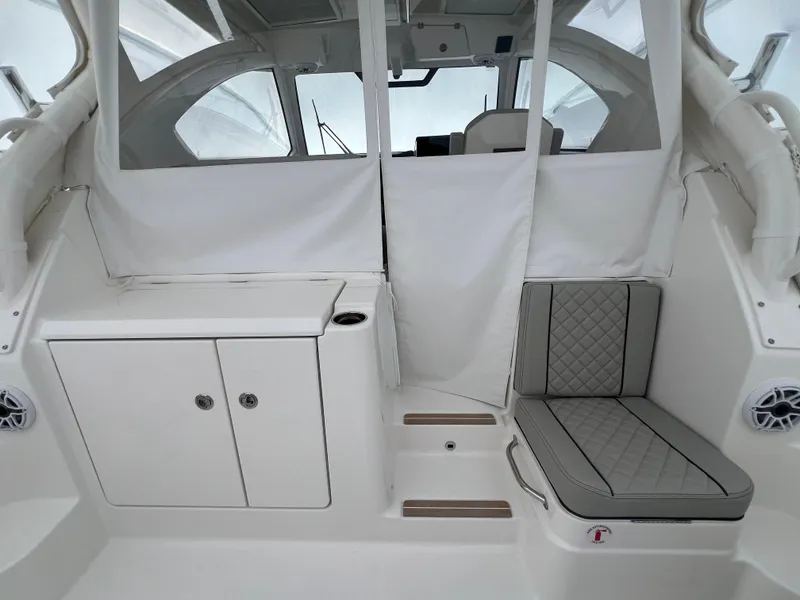 Slide: The Image of 2025 Pursuit OS 325 Offshore interior with seating and storage. - 49