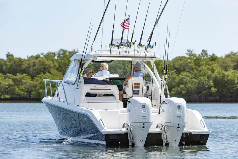 Slide: The Image of 2025 Pursuit OS 325 Offshore boat seat with quilted cushion and cup holders. - 5