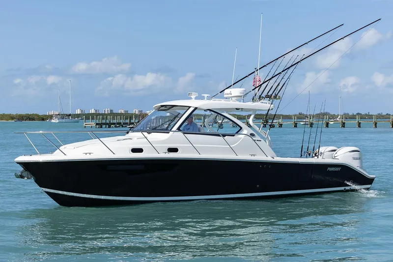 Slide: The Image of Open hatch of 2025 Pursuit OS 325 Offshore boat, showing interior compartment. - 8