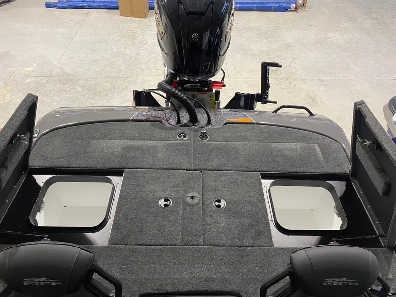 Slide: The Image of 2025 Skeeter ZXR21 boat interior with motor, showcasing seating and storage compartments. - 11