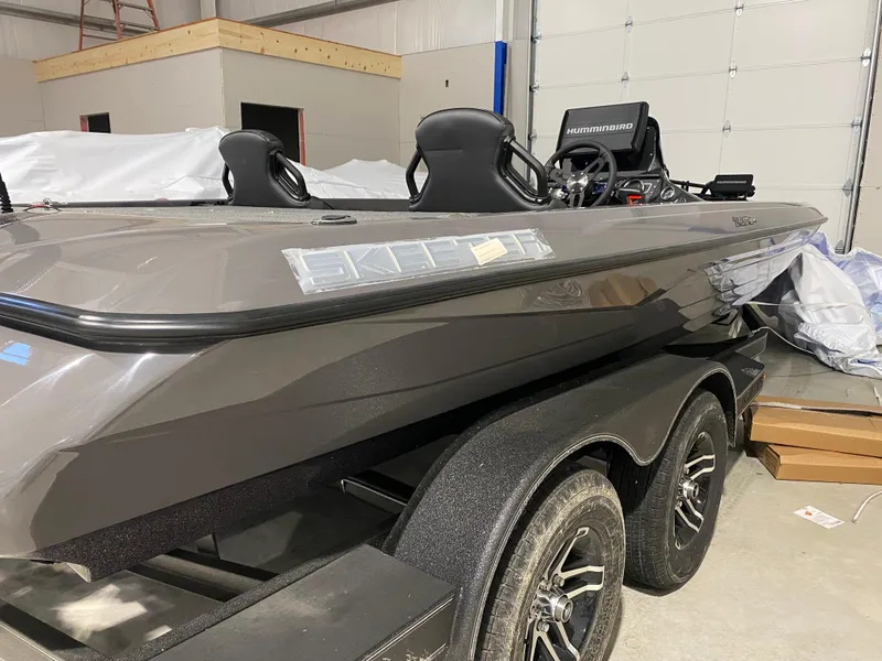 Slide: The Image of 2025 Skeeter ZXR21 boat in a garage, featuring sleek design and dual seats. - 3