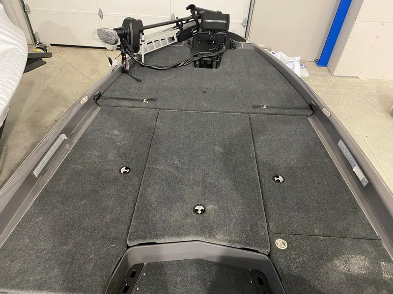 Slide: The Image of 2025 Skeeter ZXR21 fishing boat interior with trolling motor and carpeted deck. - 4