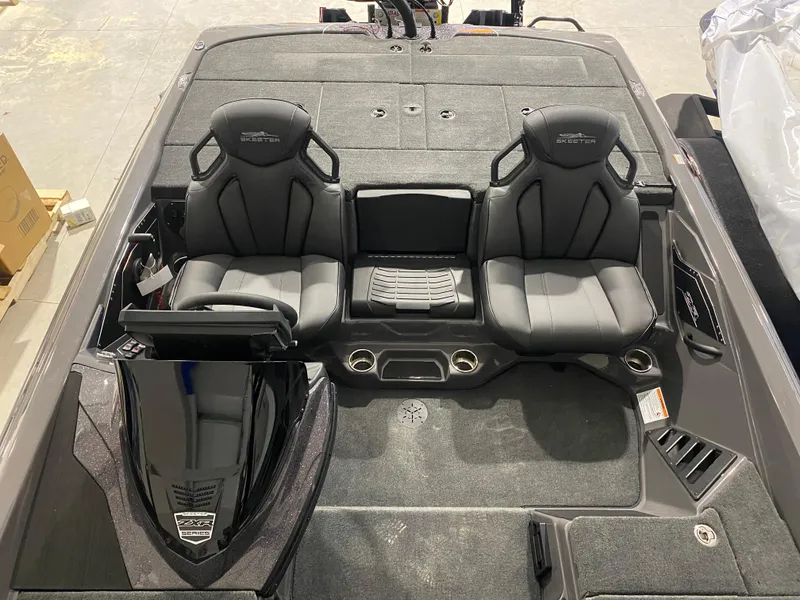 Slide: The Image of 2025 Skeeter ZXR21 boat interior with dual black seats and console. - 6