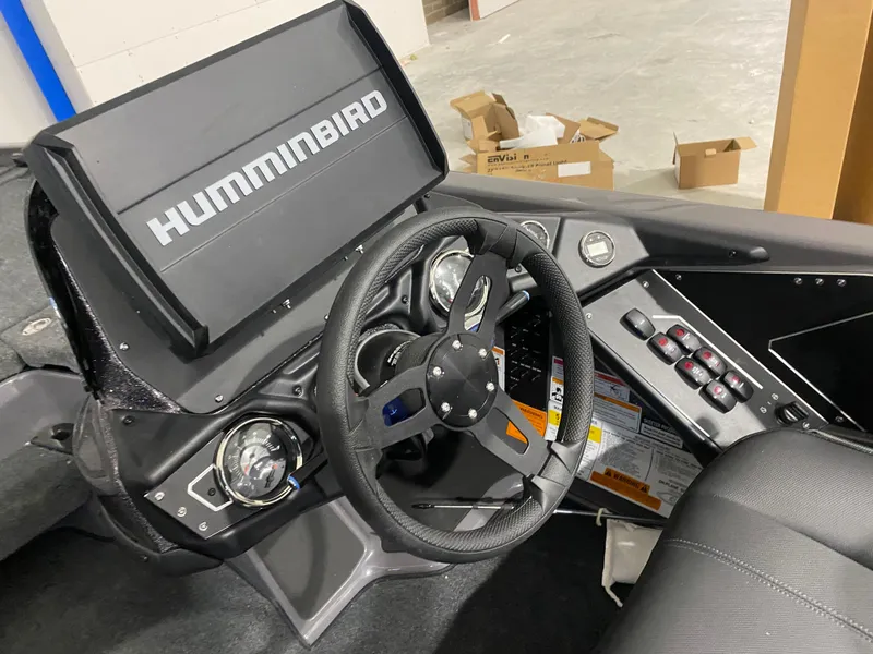 Slide: The Image of 2025 Skeeter ZXR21 boat dashboard with Humminbird electronics and steering wheel. - 8