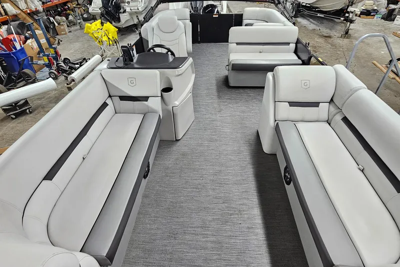 Slide: The Image of 2022 Sweetwater 2286 pontoon boat interior with gray seating and carpet. - 11