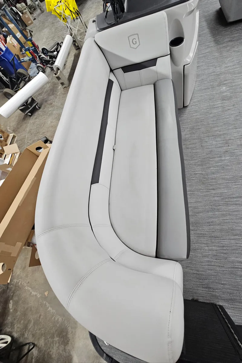 Slide: The Image of Sweetwater 2286 2022 boat seating, gray upholstery, cup holder, and storage compartment. - 12