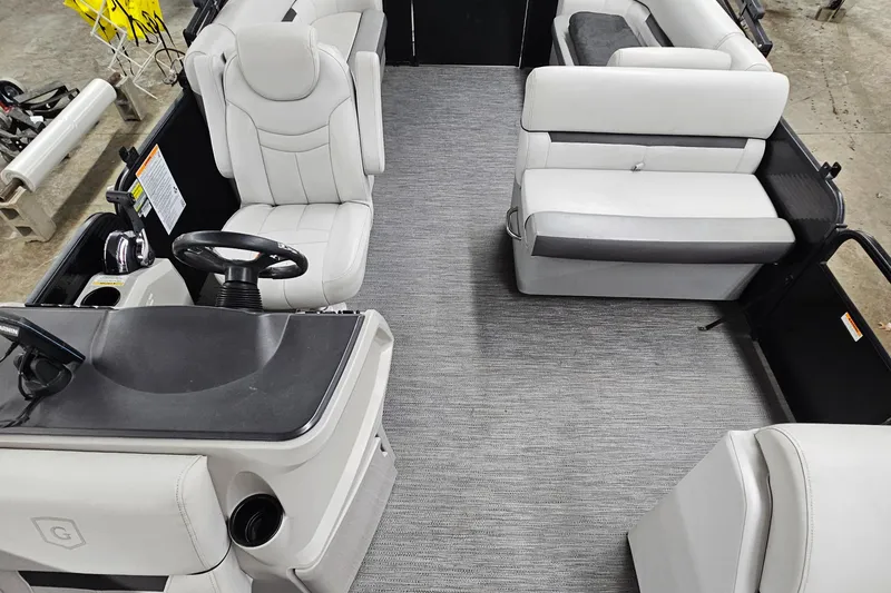 Slide: The Image of 2022 Sweetwater 2286 boat interior with gray seating and steering console. - 14