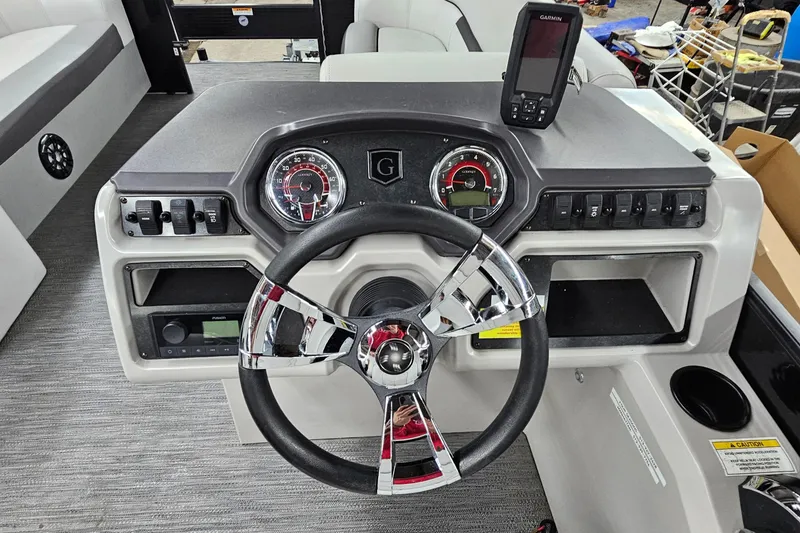 Slide: The Image of 2022 Sweetwater 2286 boat dashboard with steering wheel and gauges. - 15