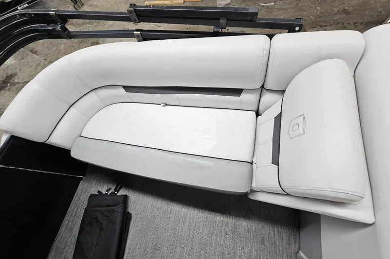 Slide: The Image of 2022 Sweetwater 2286 boat interior with white cushioned seating. - 19