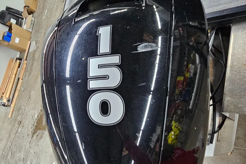 Slide: The Image of Close-up of a 2022 Sweetwater 2286 boat engine with "150" label. - 5