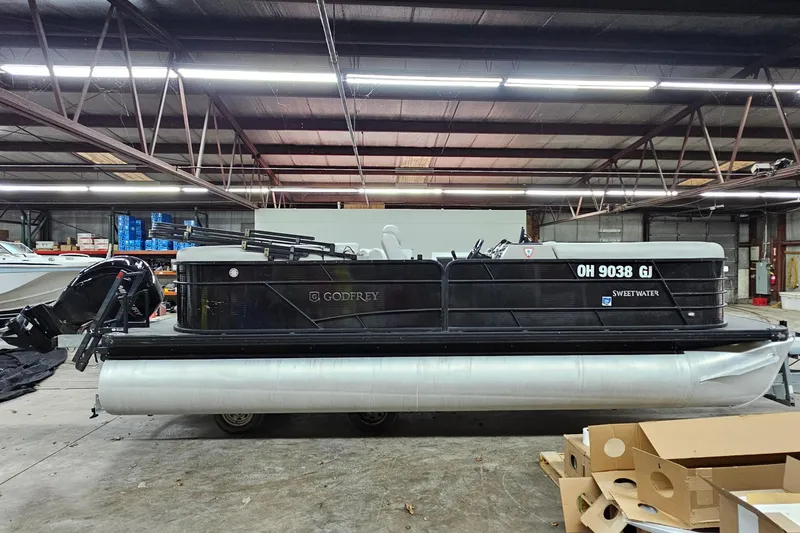 Slide: The Image of 2022 Sweetwater 2286 pontoon boat in a warehouse setting. - 7