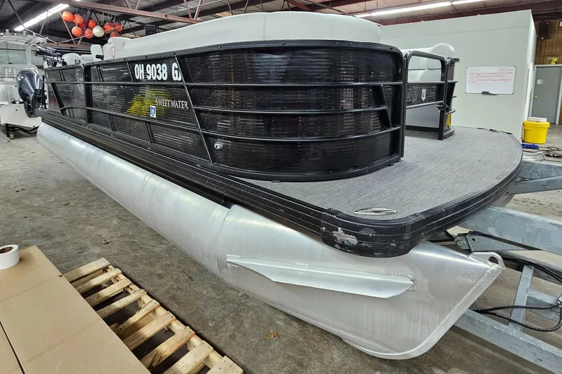 Slide: The Image of 2022 Sweetwater 2286 pontoon boat in a warehouse setting. - 8