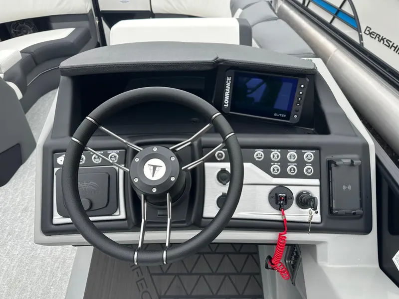 Slide: The Image of 2025 Trifecta 23 RFESS boat dashboard with steering wheel and control panel. - 9
