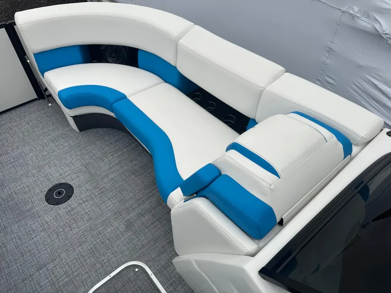 Slide: The Image of 2025 Berkshire 25 ULDCSTS boat interior with white and blue seating on gray carpet. - 10