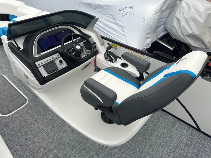 Slide: The Image of 2025 Berkshire 25 ULDCSTS boat helm with modern controls and seating. - 6