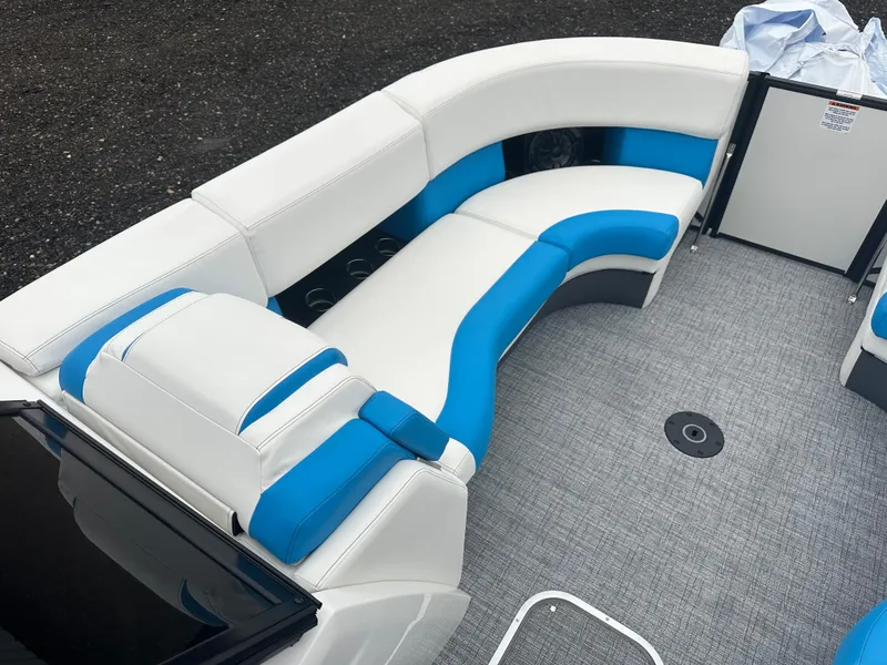 Slide: The Image of 2025 Berkshire 25 ULDCSTS boat interior with white and blue seating. - 9