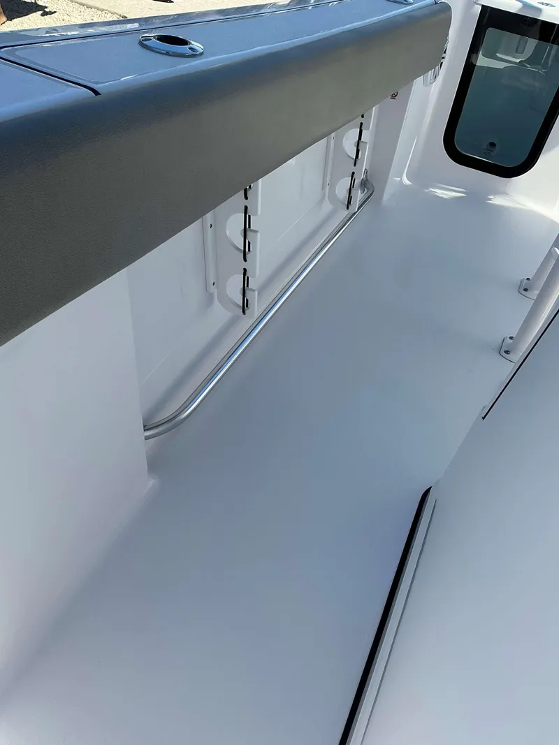 Slide: The Image of Interior view of 2025 Sportsman 212 Open boat, featuring sleek white design and stainless steel railing. - 12