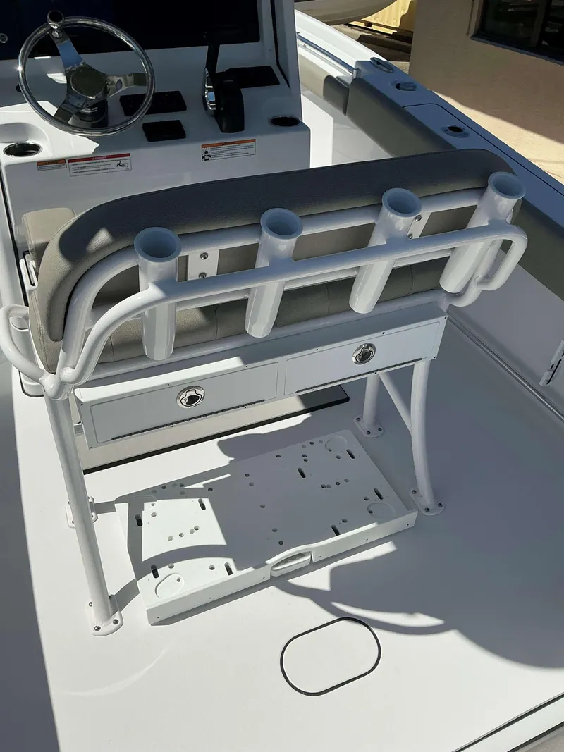 Slide: The Image of 2025 Sportsman 212 Open boat console with rod holders and storage drawers. - 19