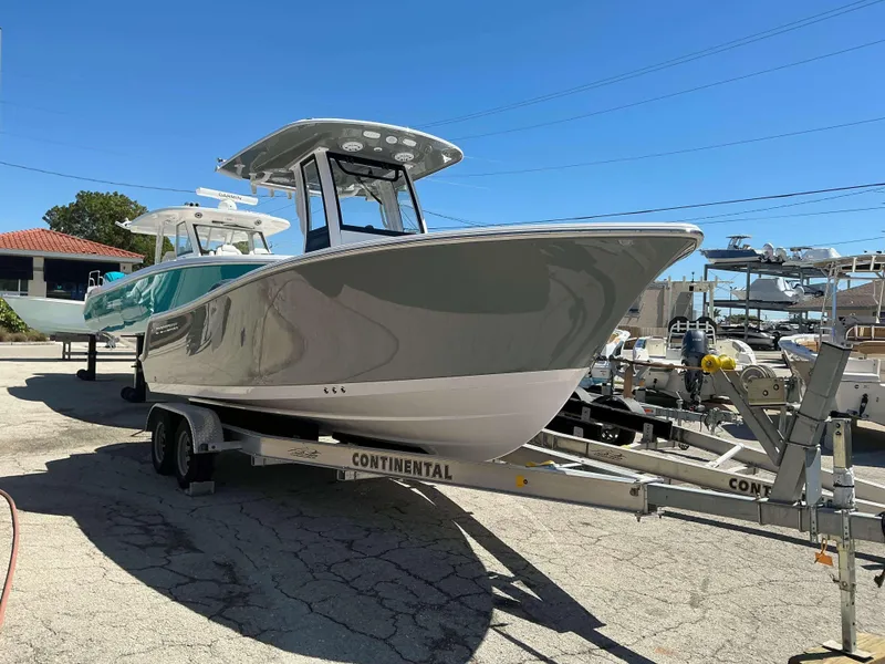 Slide: The Image of 2025 Sportsman 212 Open boat on trailer in sunny outdoor setting. - 2