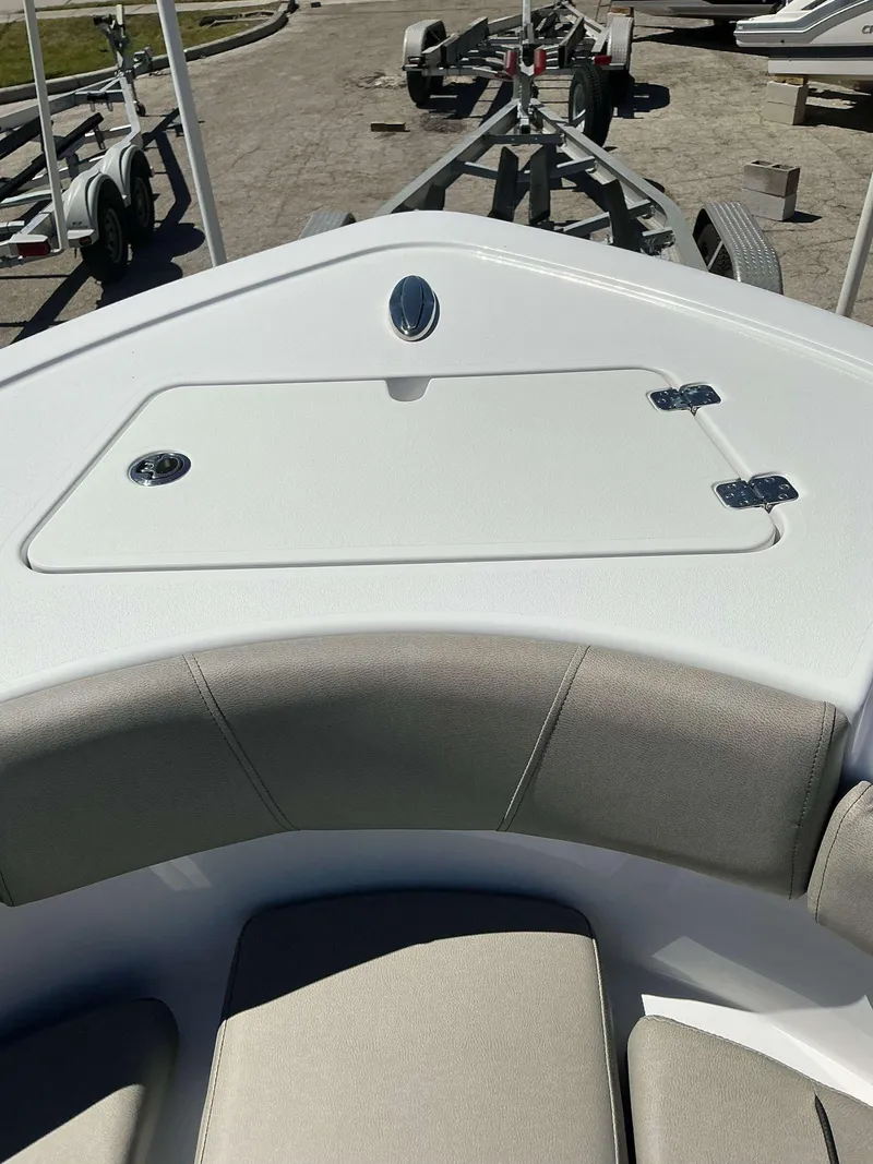 Slide: The Image of 2025 Sportsman 212 Open boat interior with cushioned seating and storage compartment. - 7