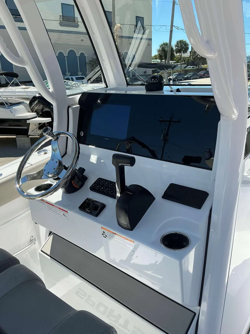 Slide: The Image of 2025 Sportsman 212 Open boat dashboard with steering wheel and controls. - 9