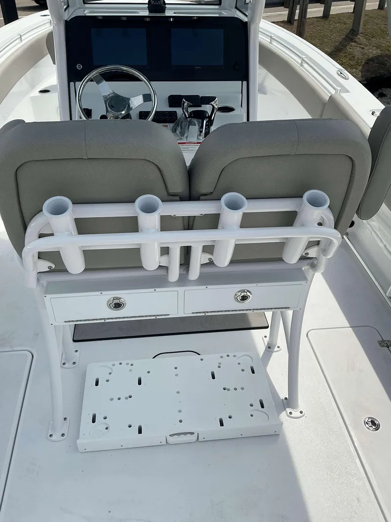 Slide: The Image of 2025 Sportsman 252 Open boat interior with rod holders and dual console setup. - 8